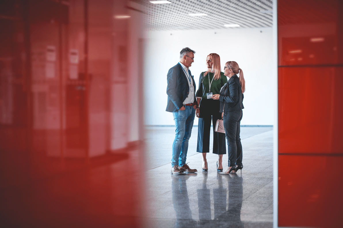 Business people discussing in a modern office lobby. Business people discussing in a modern office lobby.